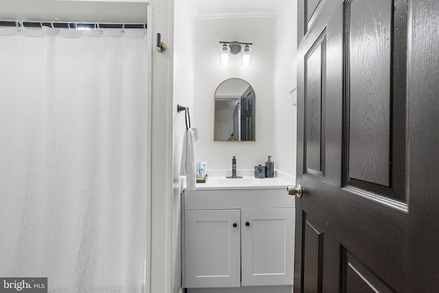 full bath with a shower with curtain, vanity, and crown molding