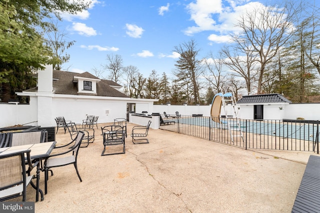 view of patio with a fenced in pool and fence