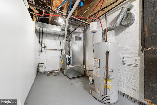 utility room with heating unit, visible vents, and gas water heater