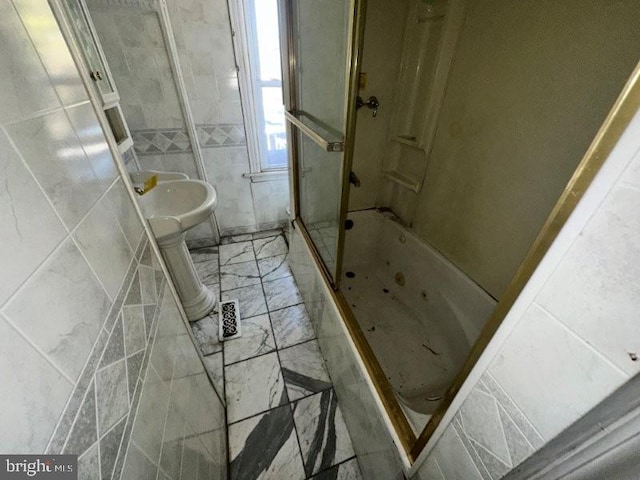 bathroom featuring tile walls, visible vents, marble finish floor, and  shower combination