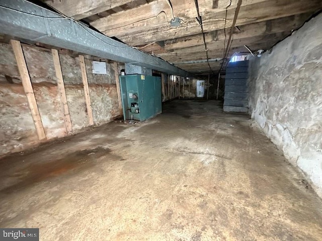 unfinished basement with heating unit and water heater