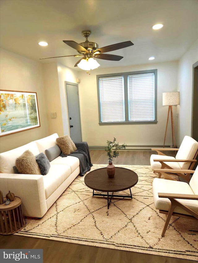 living area with recessed lighting, a ceiling fan, and wood finished floors