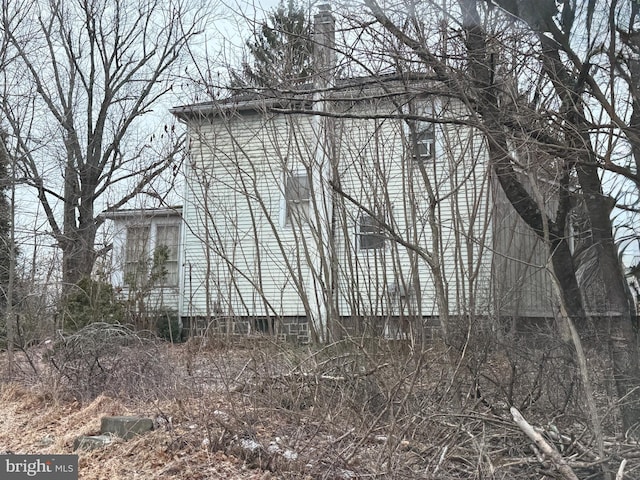 view of property exterior featuring a chimney