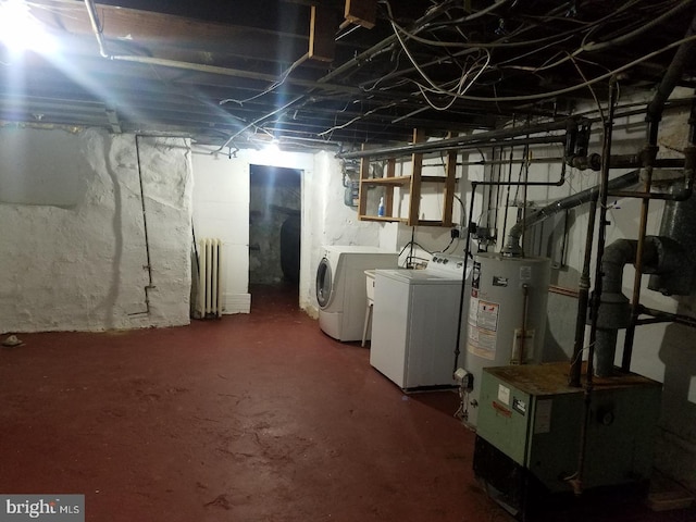 4408 Sherwood Rd, Philadelphia, PA 19131 - unfinished below grade area featuring washing machine and clothes dryer, gas water heater, and radiator