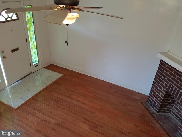 foyer entrance with baseboards and wood finished floors