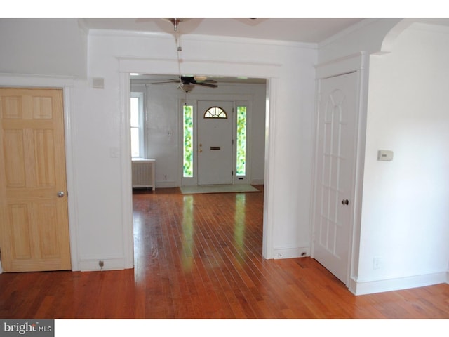 4408 Sherwood Rd, Philadelphia, PA 19131 - foyer entrance featuring radiator, crown molding, baseboards, hardwood / wood-style floors, and a ceiling fan