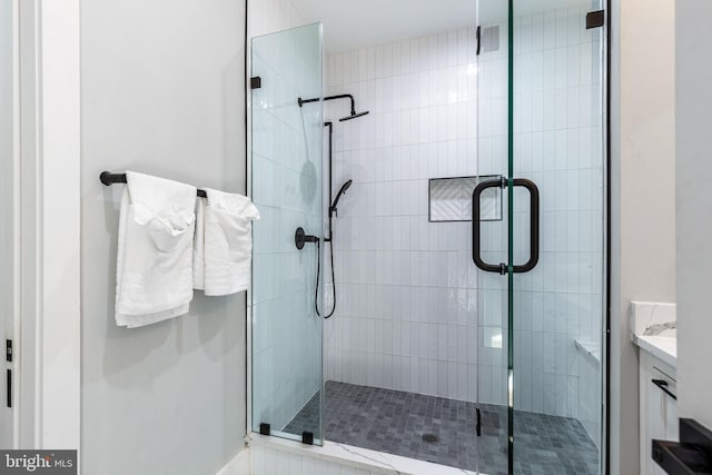 full bath featuring vanity and a stall shower