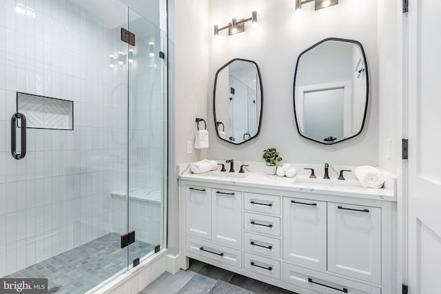 full bath featuring a shower stall, double vanity, and a sink