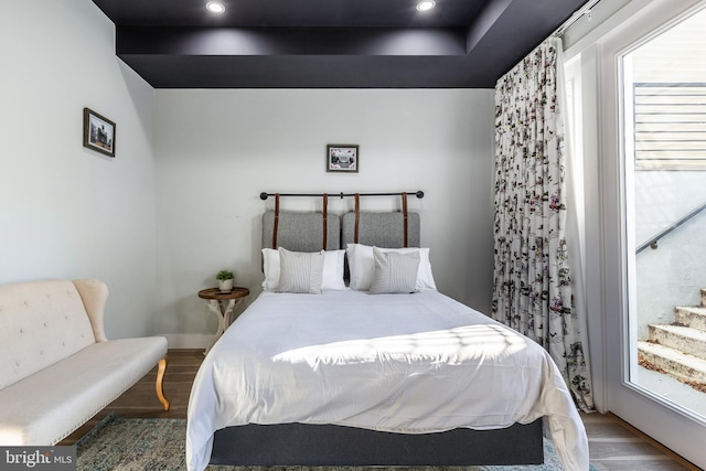 bedroom with recessed lighting and wood finished floors