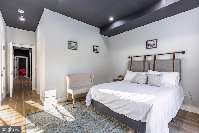 bedroom with recessed lighting and wood finished floors