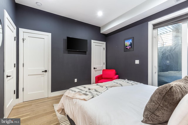 bedroom with visible vents, baseboards, access to outside, and light wood finished floors