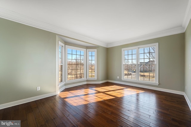 unfurnished room with a healthy amount of sunlight, baseboards, and wood-type flooring