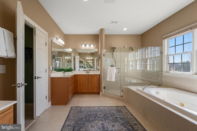 full bathroom featuring tile patterned floors, visible vents, a jetted tub, a shower stall, and vanity