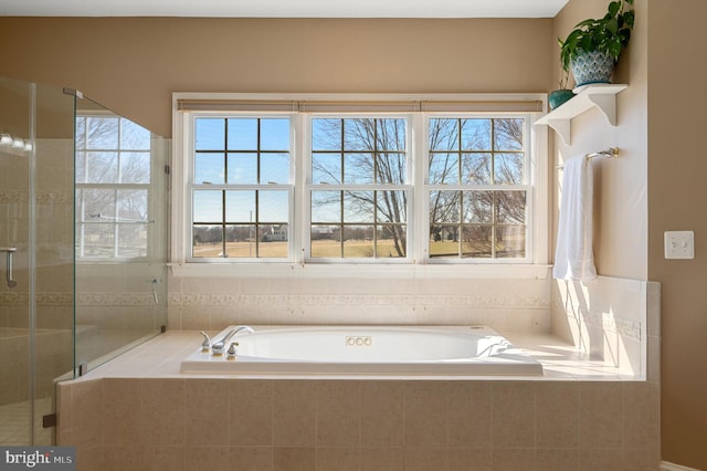 bathroom featuring a garden tub and a stall shower