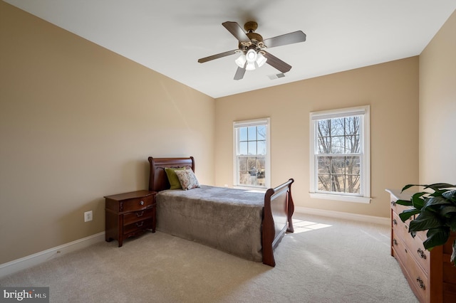 bedroom featuring visible vents, baseboards, carpet, and a ceiling fan