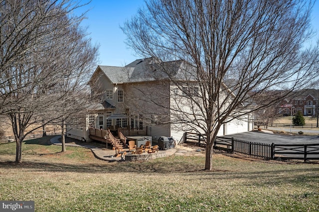 view of side of property with a garage, a lawn, driveway, and fence