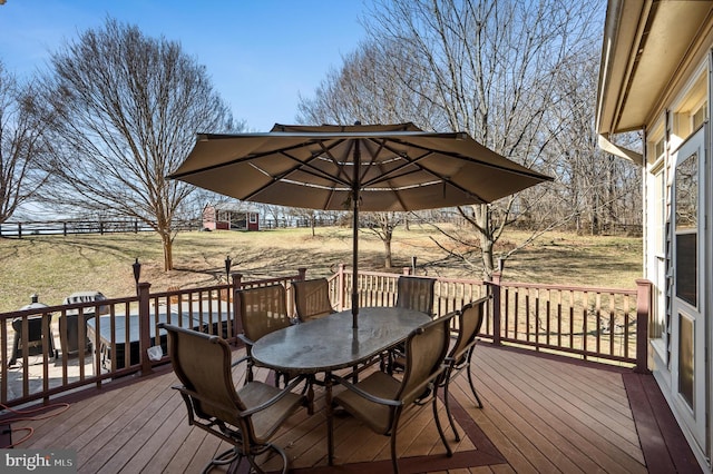 wooden terrace featuring outdoor dining area