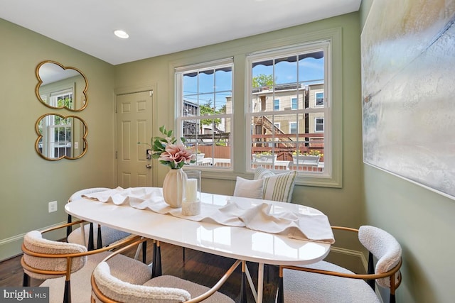 dining room featuring baseboards, recessed lighting, and wood finished floors