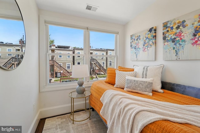 bedroom featuring baseboards and visible vents