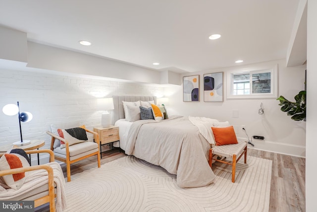 bedroom with baseboards, recessed lighting, and wood finished floors