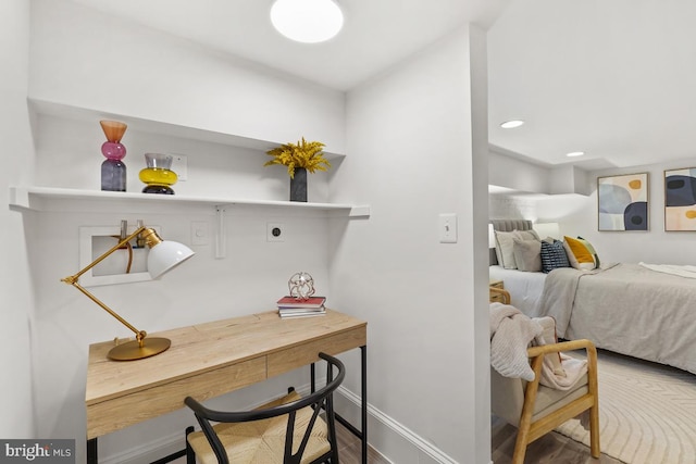 interior space featuring recessed lighting, baseboards, and wood finished floors