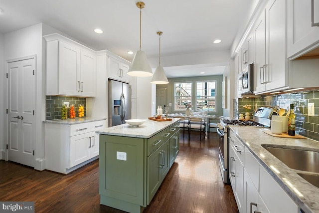 kitchen featuring dark wood-style flooring, recessed lighting, white cabinets, tasteful backsplash, and stainless steel appliances