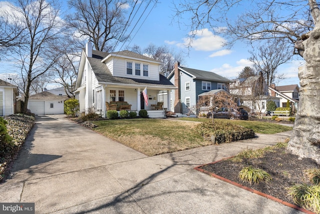 view of front of house featuring a front yard, a porch, a chimney, an outdoor structure, and a garage