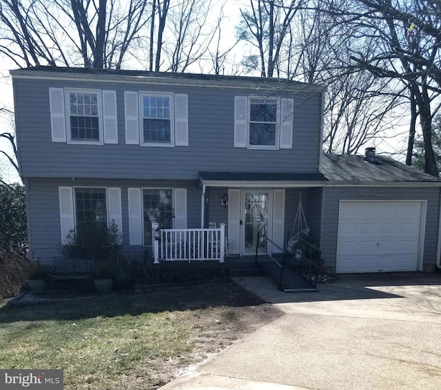 view of front facade with driveway, a porch, and an attached garage