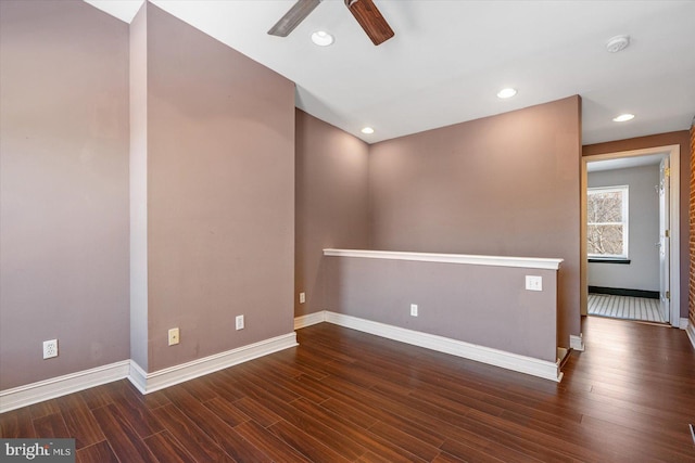 spare room with recessed lighting, baseboards, and wood finished floors