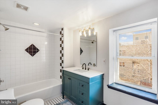 full bath with visible vents, toilet, washtub / shower combination, and vanity