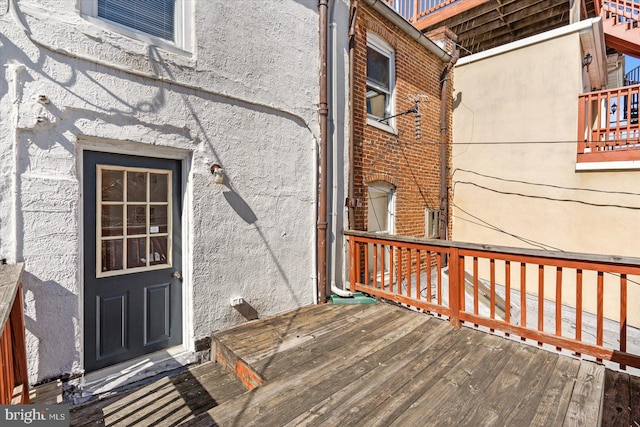 property entrance featuring brick siding and stucco siding