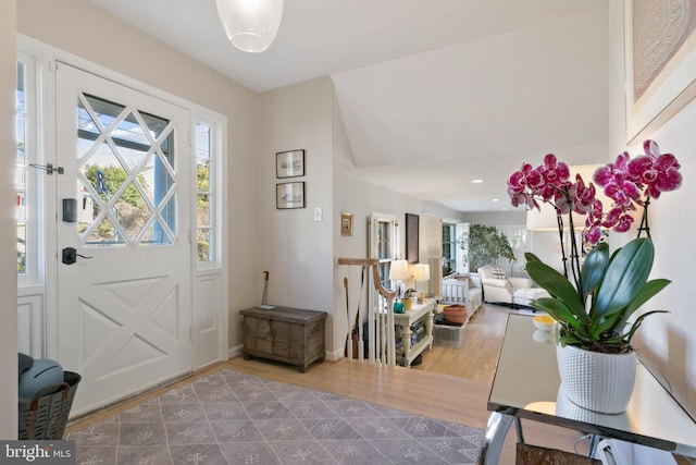 foyer with recessed lighting, wood finished floors, and baseboards