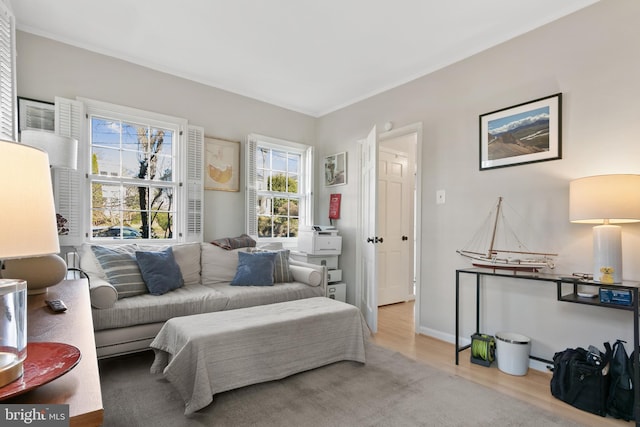 sitting room with baseboards and wood finished floors