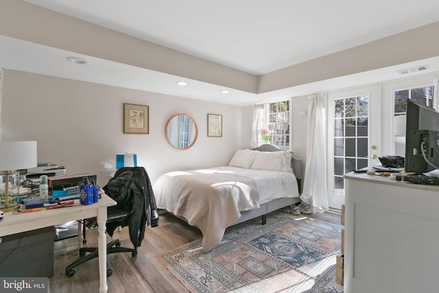 bedroom featuring recessed lighting, wood finished floors, and visible vents