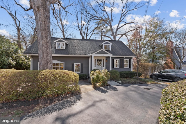 cape cod home with a shingled roof