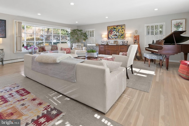 living area with recessed lighting, light wood-type flooring, and baseboard heating