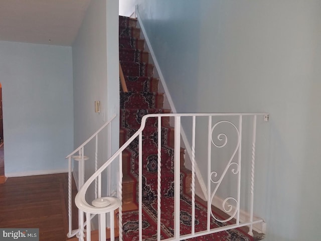 staircase with wood finished floors