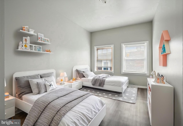 bedroom featuring baseboards and dark wood finished floors