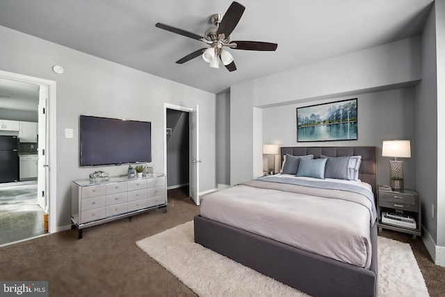 bedroom with baseboards, carpet floors, a ceiling fan, and freestanding refrigerator