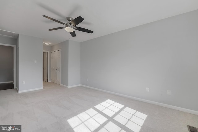 unfurnished bedroom featuring attic access, baseboards, visible vents, and light carpet