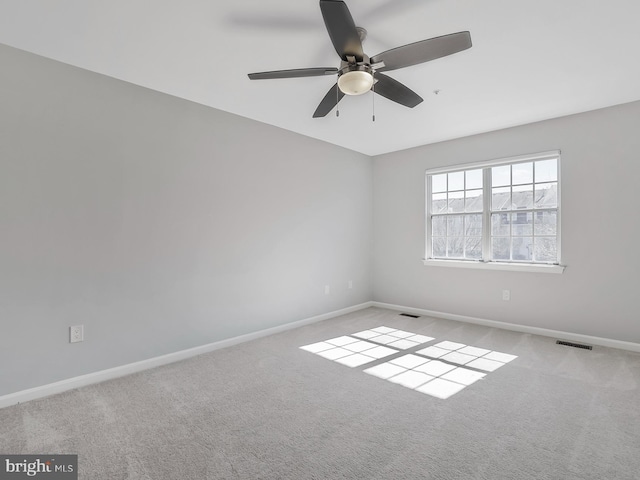 empty room featuring visible vents, baseboards, and carpet