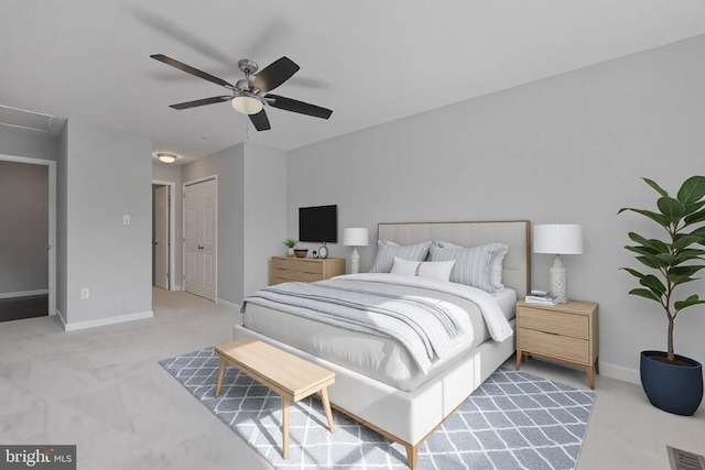 carpeted bedroom with visible vents, baseboards, a closet, and ceiling fan