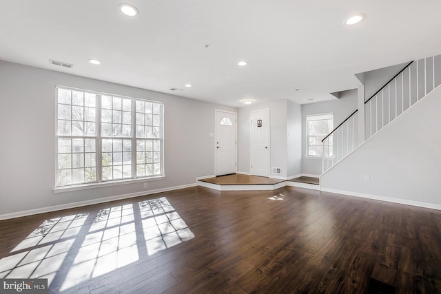 entryway with a healthy amount of sunlight, wood finished floors, visible vents, baseboards, and recessed lighting