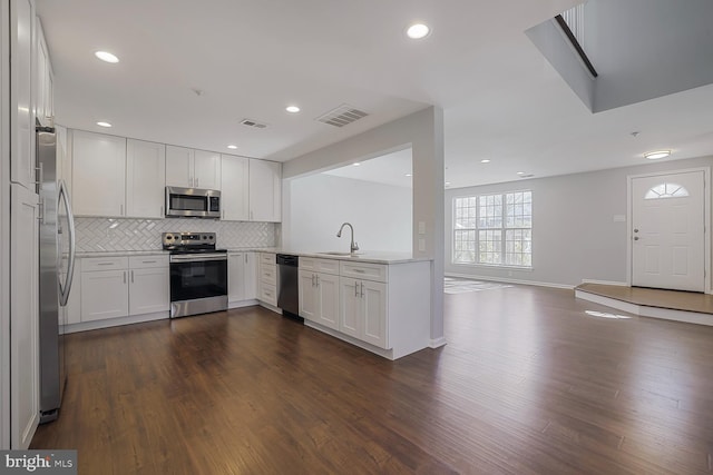 kitchen featuring dark wood finished floors, visible vents, appliances with stainless steel finishes, and a sink