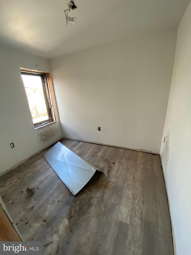 unfurnished room with wood finished floors