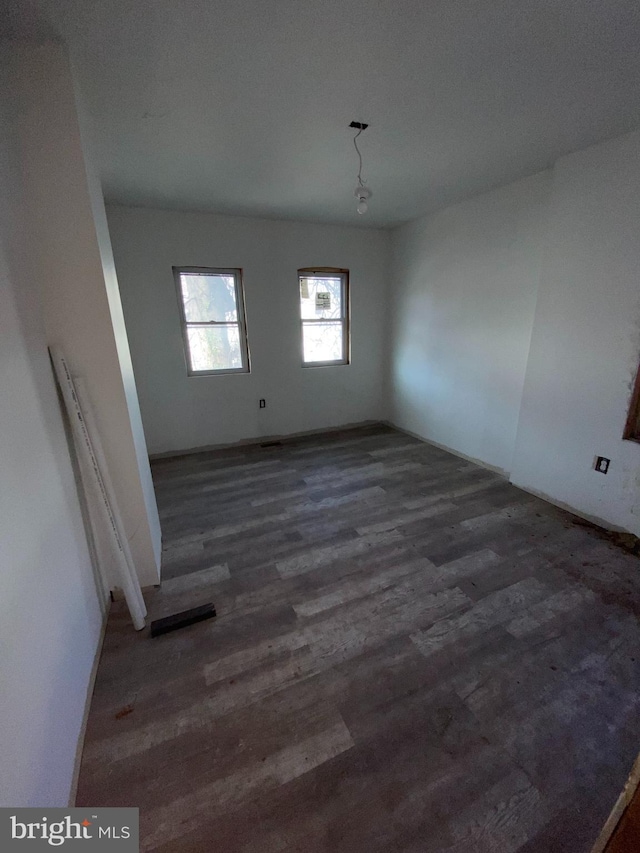 unfurnished room featuring wood finished floors and visible vents