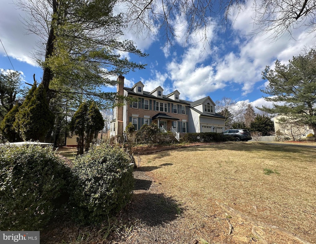 exterior space with a front yard and a chimney