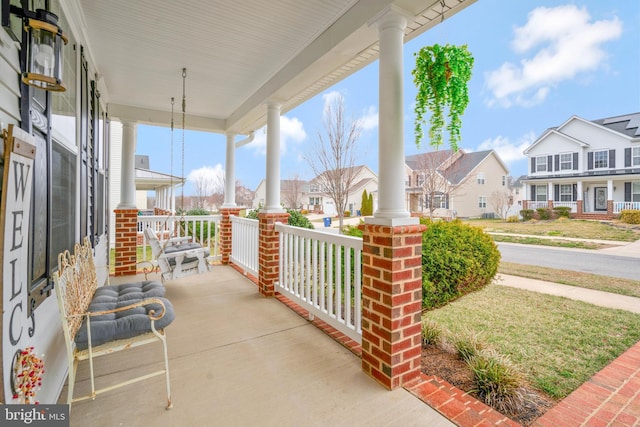 view of patio / terrace with a porch and a residential view