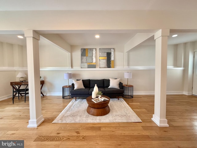 sitting room with recessed lighting, decorative columns, baseboards, and wood finished floors