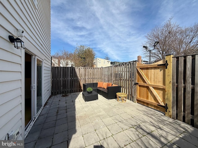 view of patio / terrace with an outdoor hangout area, a fenced backyard, and a gate